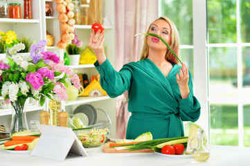 beautiful emotional young woman cooking in kitchen