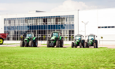 new tractors are standing next to the trading pavilion for sale in Kiev region, Ukraine.