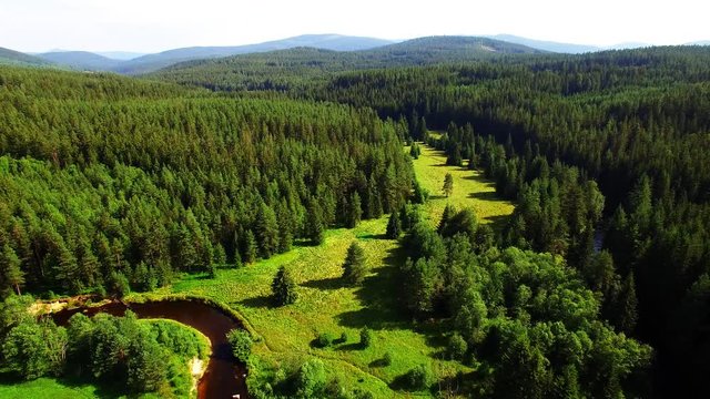 Camera flight over Gold-bearing river Kremelna in National Park Sumava. Amazing destination for hiking. Mountains in Czech Republic, Central Europe.