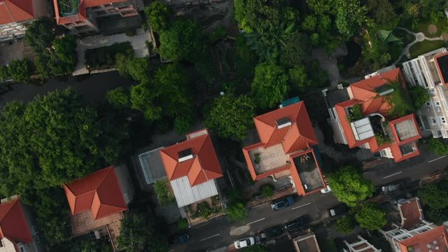 A drone flies over rich apartment buildings, pitchforks. On the roofs of buildings we see solar panels, on calm streets there are cars, there is a lot of greenery around