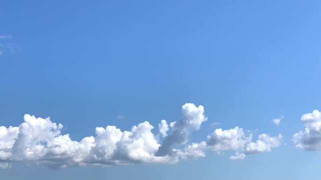 Time Lapse Blue Sky White Clouds. Clouds grow anf than fill all frame.