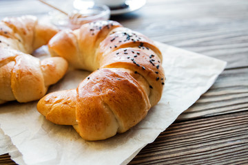 croissant on the textured wooden background top view, cozy and delicious breakfast. Rustic background with copy space