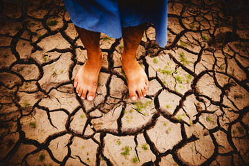 Feet of Farmer on dry ground. Global warming crisis,  Economic crisis concept