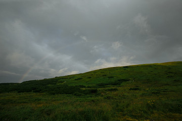 rainbow after rain in the mountains