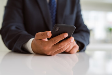 Close up of business man hands using smarpthone