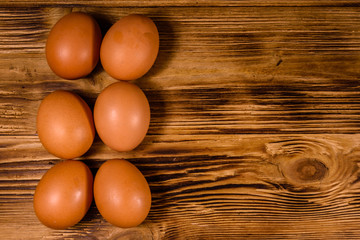 Pile of the hen eggs on wooden table. Top view