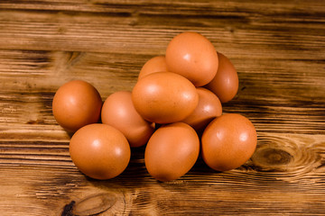 Pile of the hen eggs on wooden table