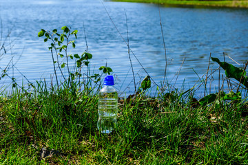 Plastic bottle with the clear water on wooden table