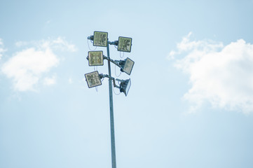 High mast of spot light on blue sky background.