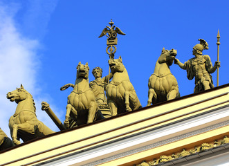 Fototapeta na wymiar Classical style sculptural group on the top of the building