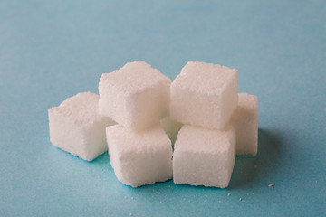 Sugar cubes on blue background