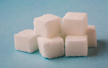 Sugar cubes on blue background
