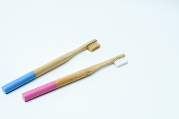 pink and blue  bamboo toothbrushes on white  background. Place for text. Ecoproduct. eco-friendly