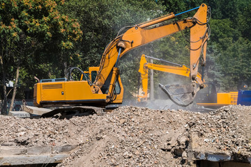 Excavators work at a construction dump.