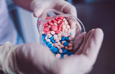 scientist doctor pours pills on his hand