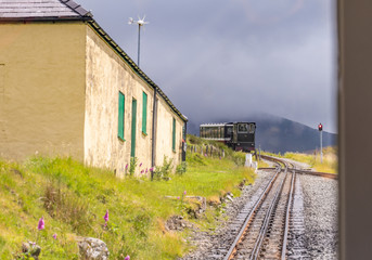 Steam train arriving at Halfway House junction on its inward bound journey from the summit of Mount Snowdon on the Mount Snowdon Railway Line