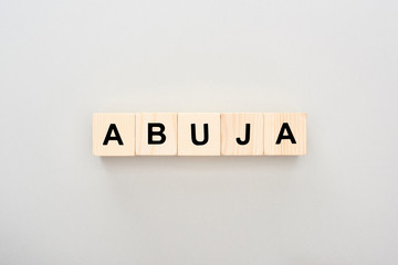 top view of wooden blocks with Abuja lettering on grey background