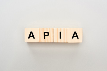 top view of wooden blocks with Apia lettering on grey background