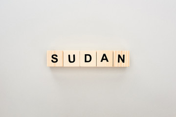 top view of wooden blocks with Sudan lettering on white background