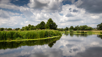 the river stour at fiddleford mill with clouds and reflections in river