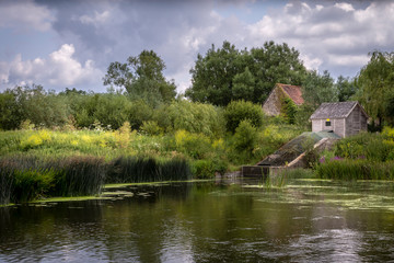 the river stour at fiddleford mill with clouds and reflections in river