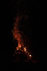 Fototapeta na wymiar Night bonfire with rising up sparks