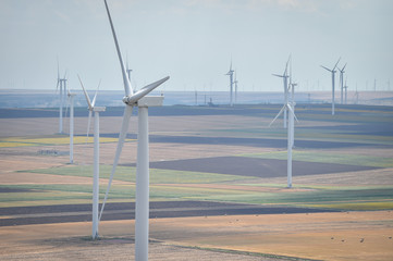 Wind turbines in a wind farm with a dramatic stormy sky in the background