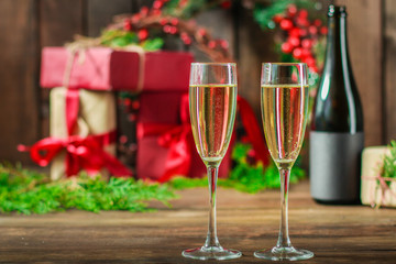champagne in transparent glasses and a bottle (New Year's atmosphere, Christmas) of happy holidays! top food background. copy space