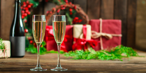champagne in transparent glasses and a bottle (New Year's atmosphere, Christmas) of happy holidays! top food background. copy space