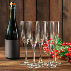 champagne in transparent glasses and a bottle (New Year's atmosphere, Christmas) of happy holidays! top food background. copy space