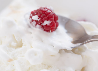 Ice cream with ripe fresh raspberries. Close-up