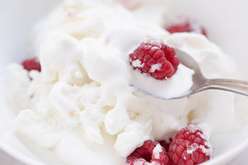 Ice cream with ripe fresh raspberries. Close-up