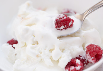 Ice cream with ripe fresh raspberries. Close-up