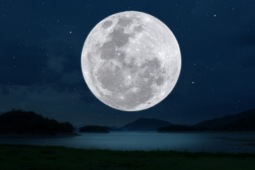 Fototapeta na wymiar Full moon over lake in the dark night.