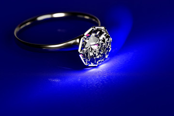 3d rendering of realistic white gold diamond ring lay on a dark blue velvet background.