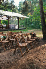 Wedding chairs set up before the ceremony. Wedding in the forest