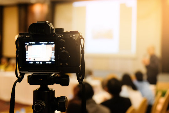 camera in business conference room recording participants and speaker echnology transformation of mirrorless camera.