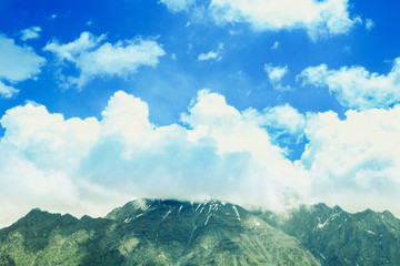 Beautiful mountain landscape. Green grass. Clouds in the sky. Travel concept.