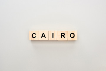 top view of wooden blocks with Cairo lettering on grey background