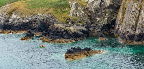 Two kayakers paddling around St Non’s Bay