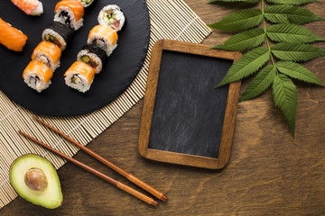 Flat lay sushi arrangement with black chalkboard