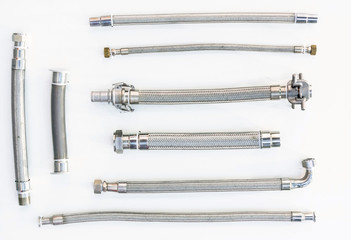 High pressure metal hoses of various formats and types on a white background, not insulated no...