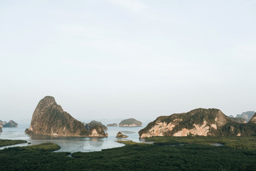Exotic and tropical dark green islands with rocks, blue sea and clear sky at Ao Phang-nga National...