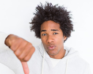 African American man over white isolated background with angry face, negative sign showing dislike...