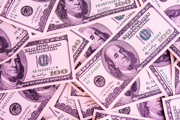 money background from 100 dollar bills in warm light