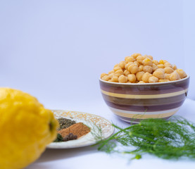 chickpeas in a bowl with spices, dill and lemon 