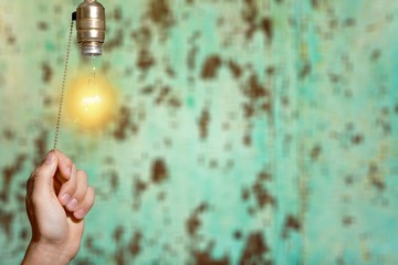 Hand turning off the bulb lamp.Turning off the light.