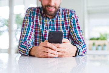 Close up of man hands using smartphone and smiling
