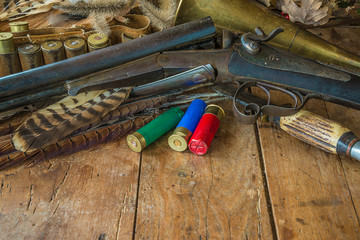 Beautiful hunting still life with vintage rifle, hunting knife, horn on the old wooden background with copy space
