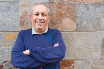 Fototapeta premium Handsome middle age senior man smiling cheerful, happy and positive with crossed arms over bricks wall background